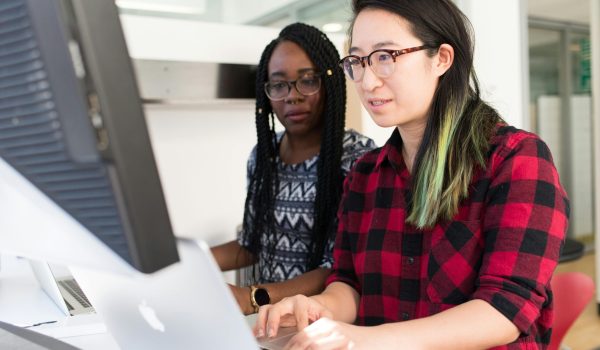 Woman Wearing Red and Black Checkered Blouse Using Macbook